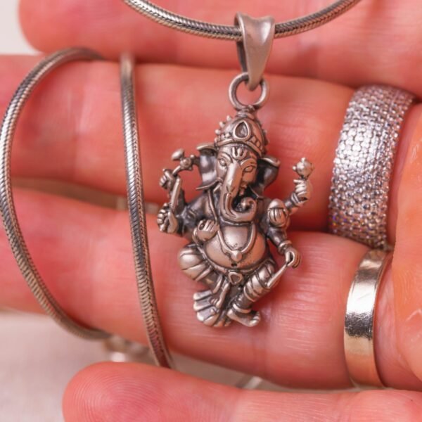 Discover this beautifully crafted pure silver pendant depicting Lord Ganesha, the auspicious deity, complete with a matching silver chain.