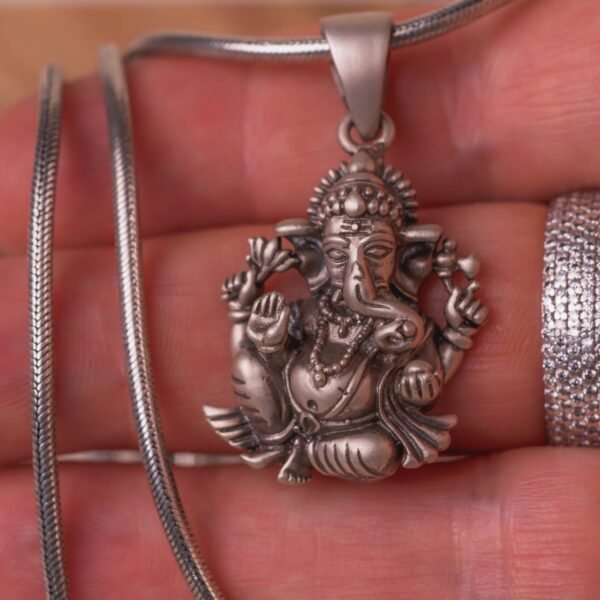 Discover this beautifully crafted pure silver pendant depicting Lord Ganesha, the auspicious deity, complete with a matching silver chain.