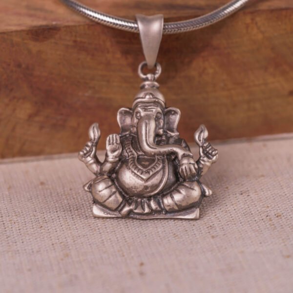 Discover this beautifully crafted pure silver pendant depicting Lord Ganesha, the auspicious deity, complete with a matching silver chain.