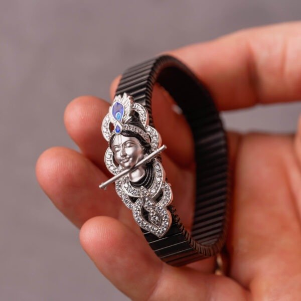 A silver bracelet with a Krishna motif is a popular and spiritually significant piece of devotional jewelry.