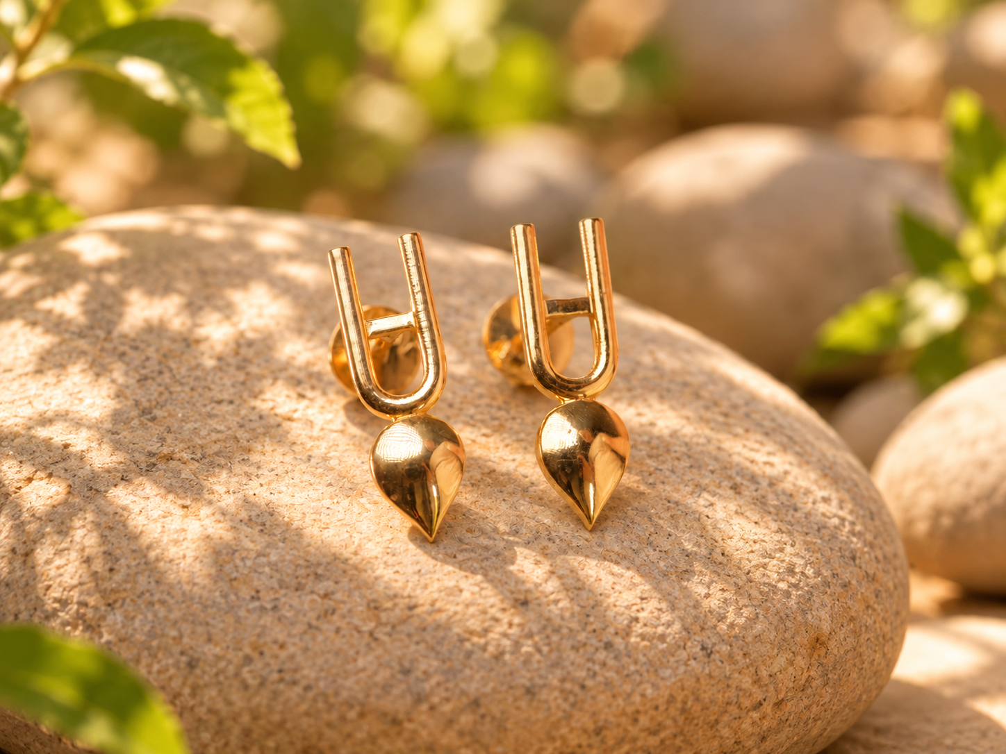 Golden Teardrop Earrings on Stone